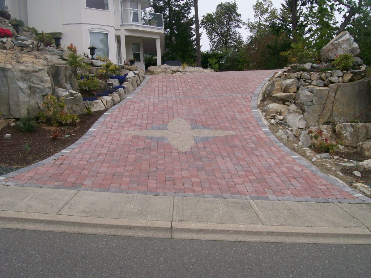 brick driveway with rock gardens
